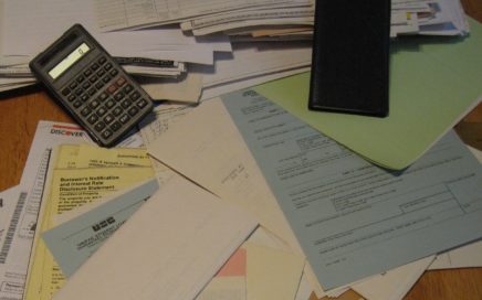 Pile of cluttered papers on a desk