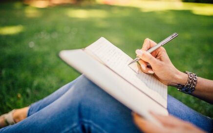 Image of person writing in book by StockSnap from Pixabay