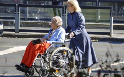 Image of woman pushing another woman in a wheelchair courtesy Pixabay