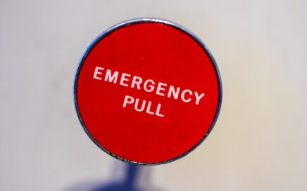 Photo of button labeled Emergency Pull courtesy Jason Leung on Unsplash