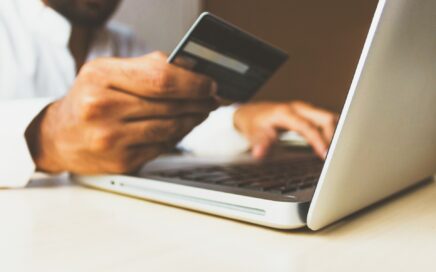 Image of person holding a credit card while using a laptop by Free stock photos from www.rupixen.com on Pixabay