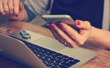 Image of person using phone and laptop courtesy Firmbee from Pixabay