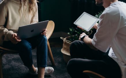A young couple talking with laptops in their laps courtesy cottonbro studio on Pexels