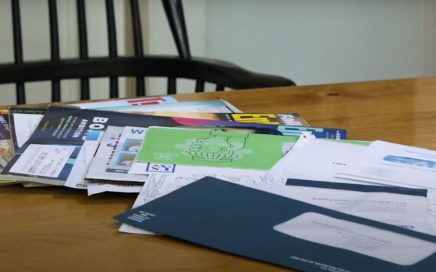 A pile of paper strewn over a table