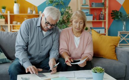 Photo of couple on couch looking at their finances by Vitaly Gariev on Unsplash